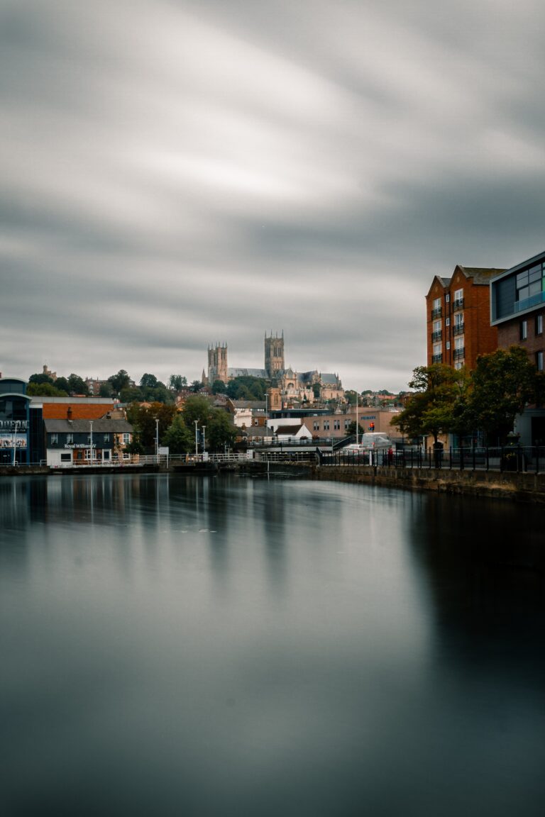 A lake in the foreground, lincoln cathedral stands in the background