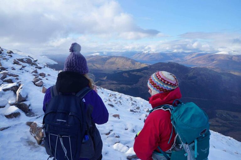 two hikers stand on top of ben nevis