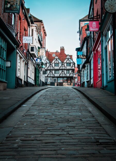 A cobbled steep hill lined with colourful shops