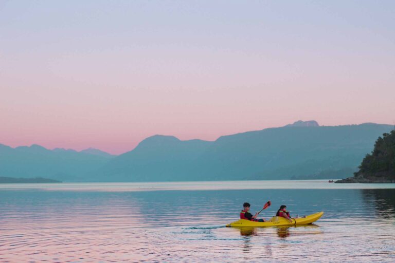 A couple kayak on the lake in Pucon
