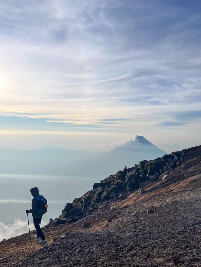 A hiker on the summit of Acatenango Volcano