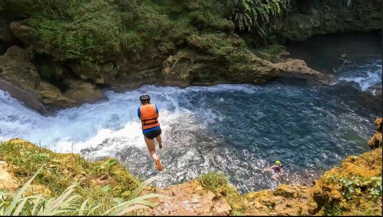 Alice is jumping into Pulhapanzak Waterfall pools